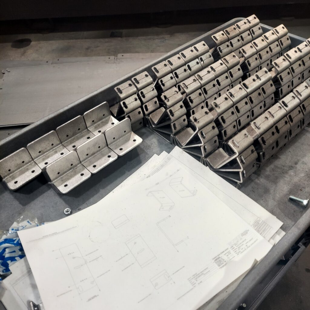 Stacks of precision press brake formed sheet metal parts