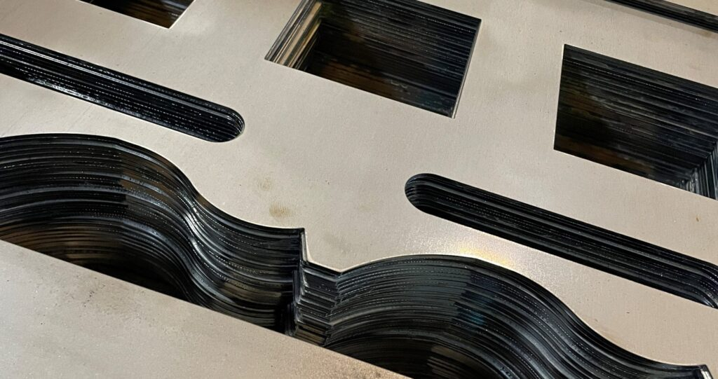 Laser cut and engraved steel parts stacked for production